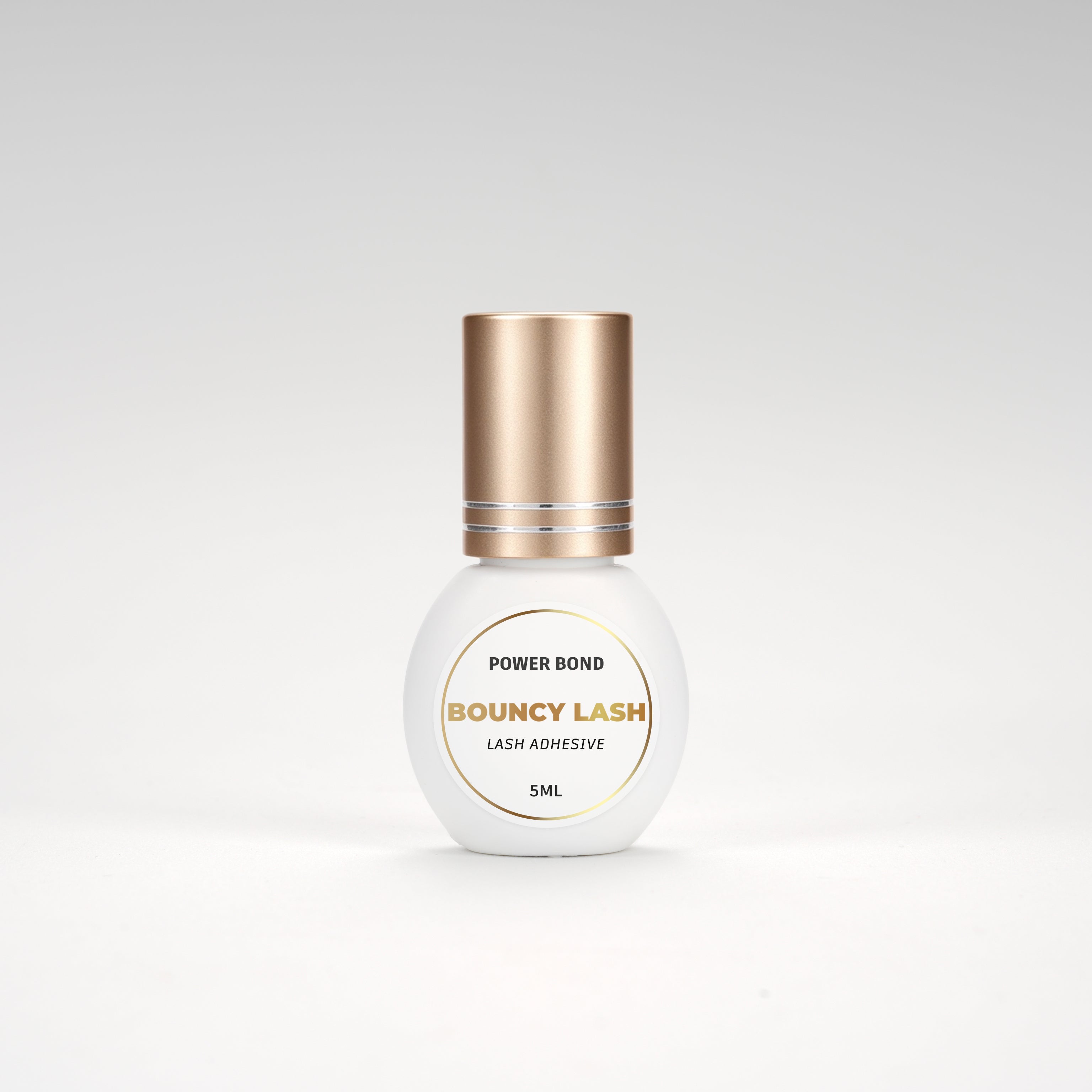 BouncyLash Power Bond lash extension adhesive in a white 5 mL bottle with a gold cap.